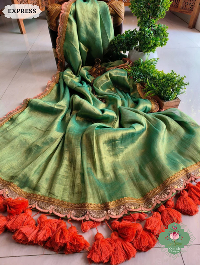 Zynah Metallic Green Linen Tissue Saree With Scalloped Lace & Orange Tassels; Custom Stitched/Ready-made Blouse, Fall, Petticoat; SKU: 2703202509