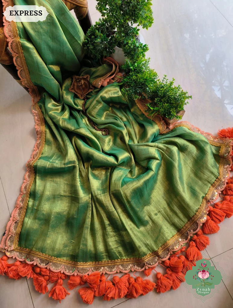 Zynah Metallic Green Linen Tissue Saree With Scalloped Lace & Orange Tassels; Custom Stitched/Ready-made Blouse, Fall, Petticoat; SKU: 2703202509