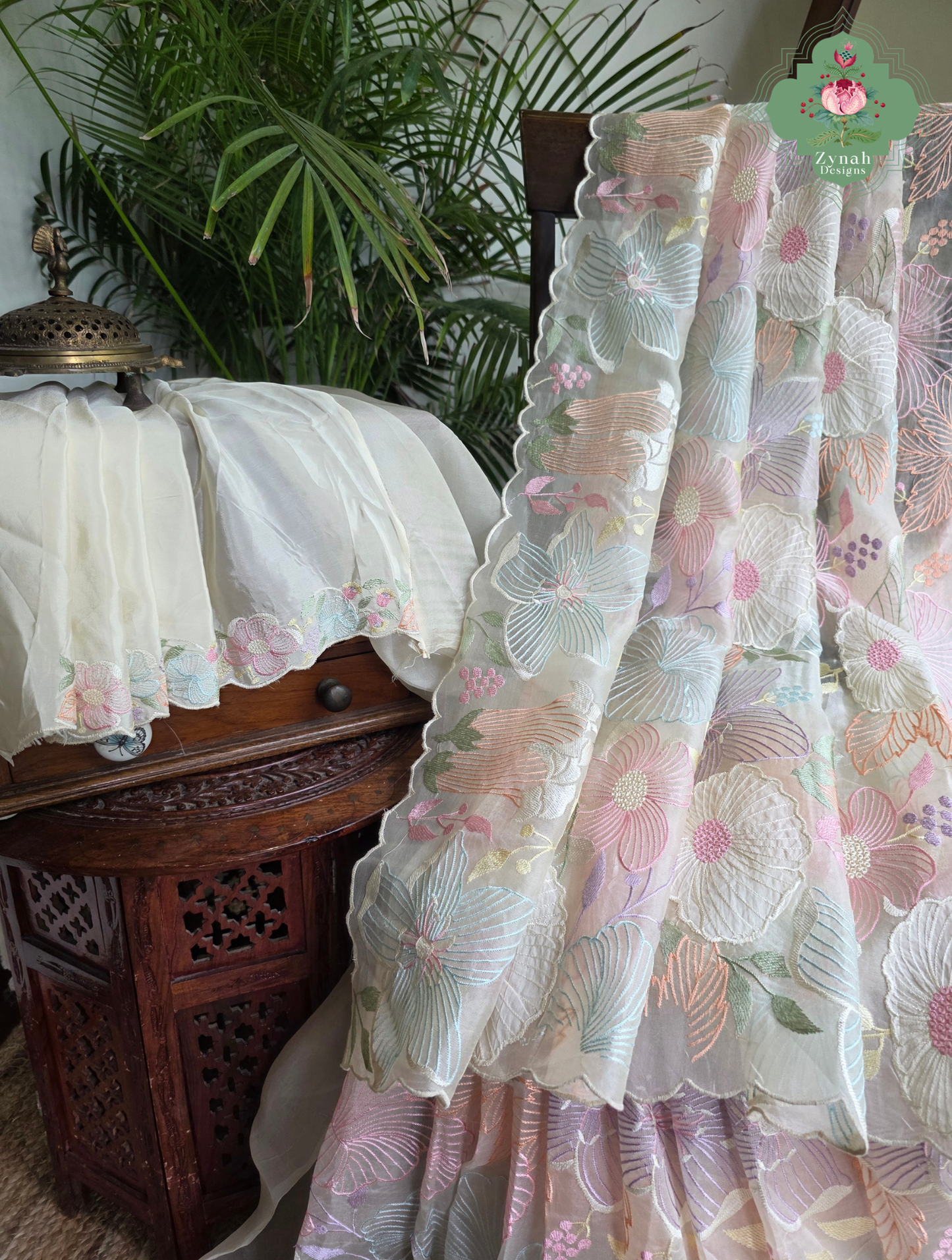 Malarika Off White Organza Silk Saree With Pastel Floral Embroidery & Patchwork