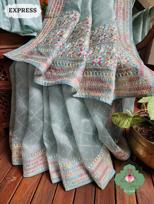 Zynah Powder Blue Organza Silk Saree With Bandhani Prints & Multi-coloured Embroidery On Pallu And Border; Custom Stitched/Ready-made Blouse, Fall, Petticoat; SKU: 1905202301