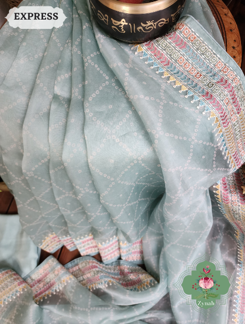 Zynah Powder Blue Organza Silk Saree With Bandhani Prints & Multi-coloured Embroidery On Pallu And Border; Custom Stitched/Ready-made Blouse, Fall, Petticoat; SKU: 1905202301
