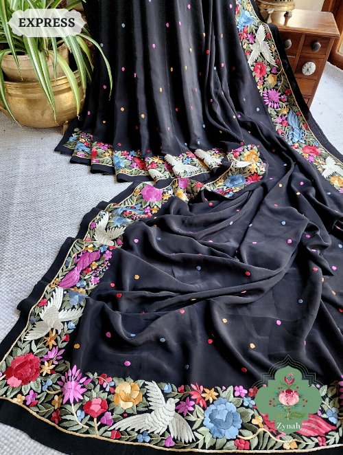 A stunning black saree made of Crepe Silk with intricate Hand-Embroidered Parsi Gara work.
