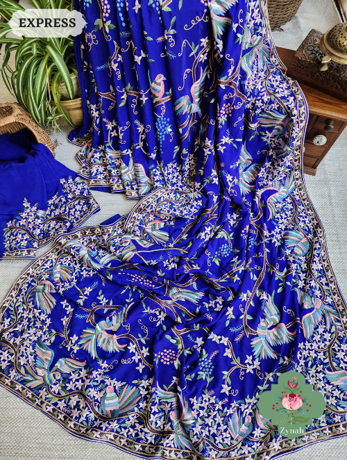 An opulent Royal Blue saree crafted from Pure Crepe Silk with intricate Hand-Embroidered Parsi Gara work.