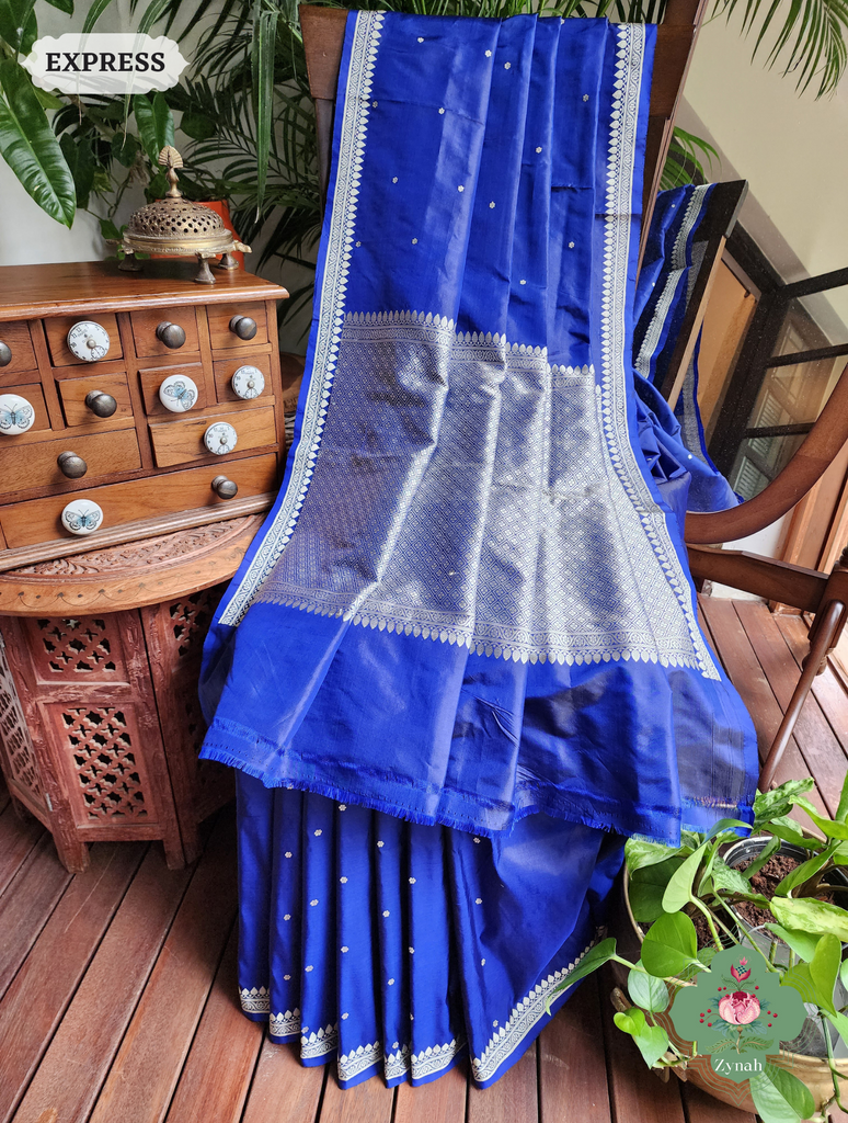 Blue Banarasi Silk Saree: Elegant silver butis, border, and pallu. Artistic, graceful, and perfect for special occasions.
