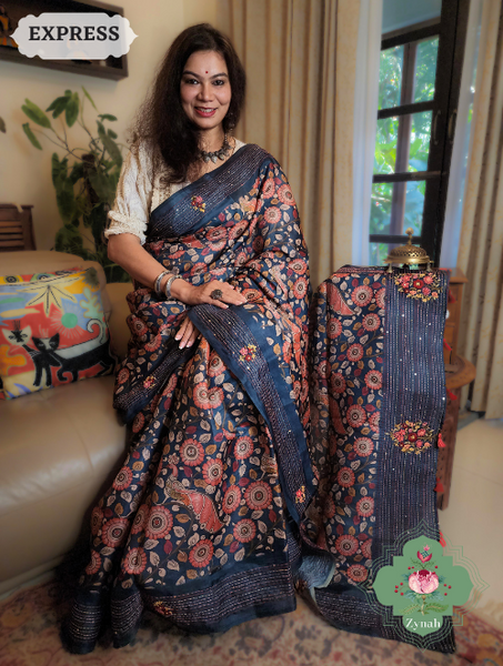 Blue Jute Tussar Kalamkari Saree with Frenchknot motifs, Kantha embroidery, and sequins. Rich blue fabric for special occasions.