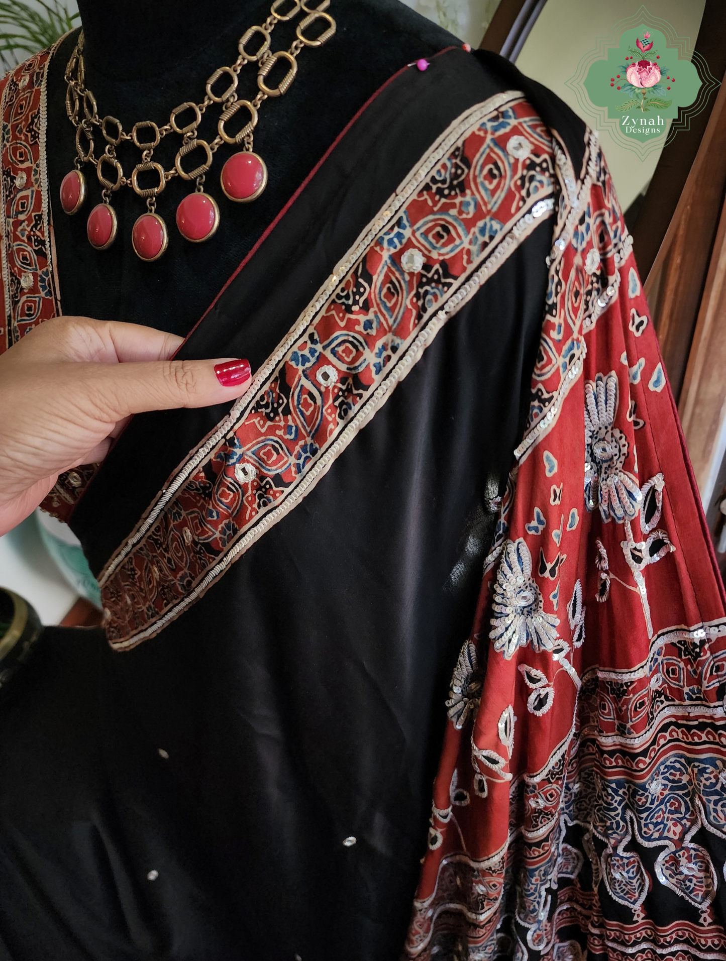 Zynah Siahra – Madder Red & Black Pure Modal Silk Ajrakh Saree with Ajrakh Hand Block Printing & Artisan Embellishments
