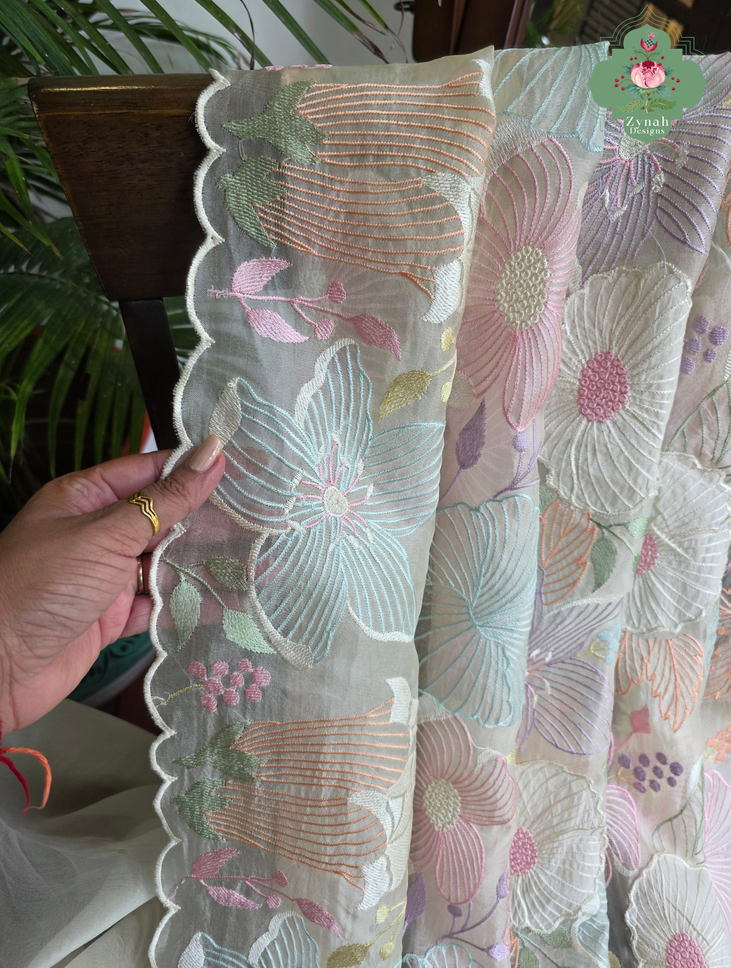 Malarika Off White Organza Silk Saree With Pastel Floral Embroidery & Patchwork