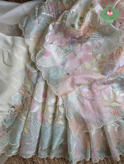 Malarika Off White Organza Silk Saree With Pastel Floral Embroidery & Patchwork