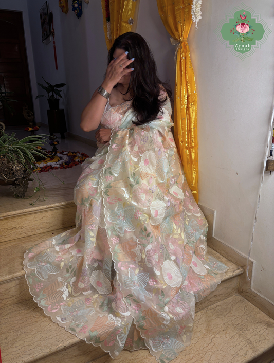 Malarika Off White Organza Silk Saree With Pastel Floral Embrodiery & Patchwork
