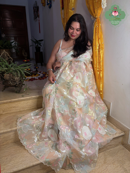 Malarika Off White Organza Silk Saree With Pastel Floral Embroidery & Patchwork