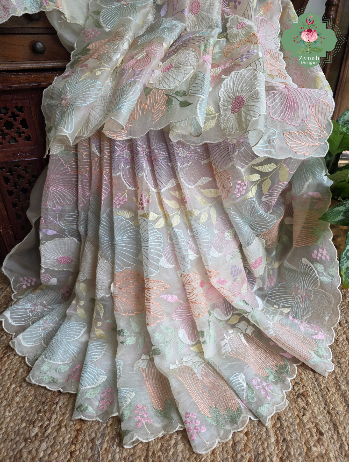 Malarika Off White Organza Silk Saree With Pastel Floral Embroidery & Patchwork