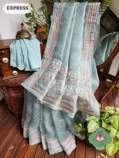 Powder Blue Organza Silk Saree: Bandhani prints & vibrant embroidery. Timeless fusion of tradition & contemporary charm.