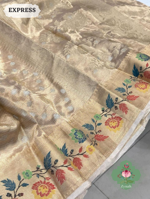 Beautiful, handwoven Banarasi double tissue silk saree with Paithani border & butis. Delicate tassels complete the look.
